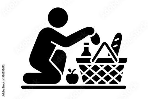 Person kneeling and packing a picnic or grocery basket with bread, apple and bottle flat vector icon