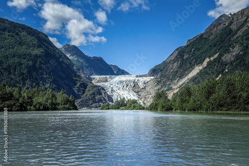 Massive Chilkat Glacier in Alaska towering above tranquil fjord waters