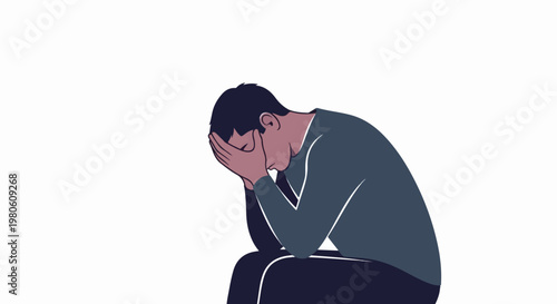 A person sits with their head in their hands, appearing to be in distress or deep thought