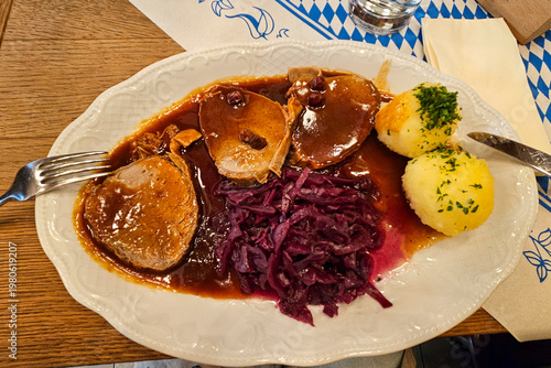 Traditional German meal with pork, dumplings and red cabbage