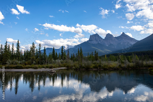 Majestic Mountain Range Reflected in Calm Alpine Lake With Fores