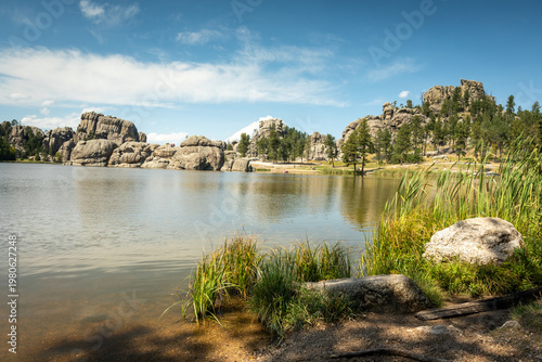 Serene Rocky Lake Landscape With Pine Trees, Granite Outcrops an