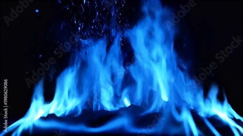 A striking image showcases vibrant blue flames dancing against a stark black background, creating a mesmerizing display of heat and light.