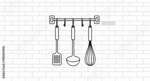 Kitchen utensils hanging on a wall rail against a brick background