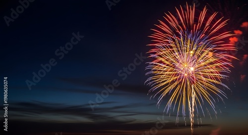 Firework exploding in night sky with clouds