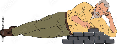 Man lying on ground talking on phone with bricks nearby