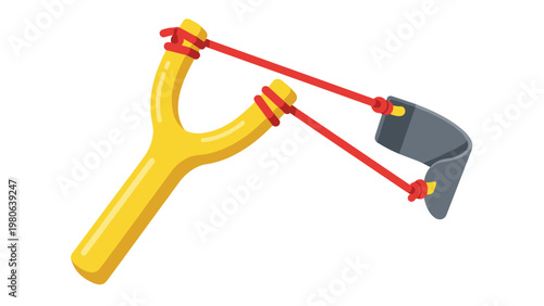 Traditional yellow slingshot with red elastic bands, symbolizing childhood play, simple toys, and mischievous fun.
