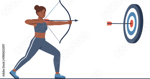 A woman in athletic wear practices archery aiming at a target indoors.