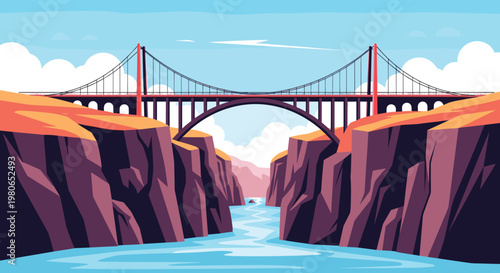 Wide angle view of a massive suspension bridge spanning across a deep rocky canyon with a river flowing through the bottom.