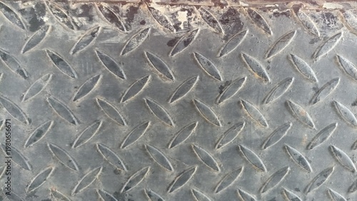 Diamond plate metal texture with industrial pattern, ideal for construction themes, mechanical design, safety surfaces, or metallic backgrounds