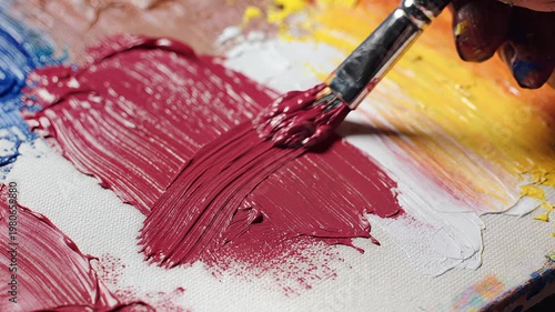 Hand painting with red brush on canvas