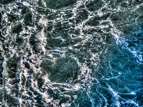 Obraz na plátně Ocean waves churning creating white sea foam texture