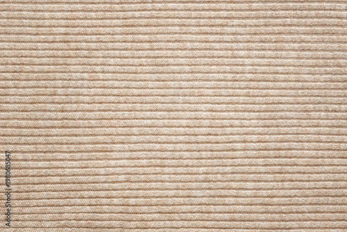 Light beige knitted background with horizontal lines