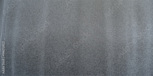 A closeup of blank grey fabric material with a rough textured surface and dark grunge textile pattern on a brushed canvas background