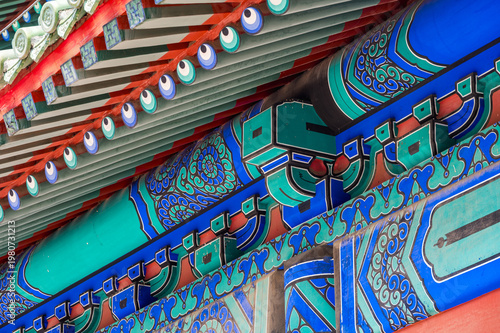 An intricate close-up reveals the colorful painted patterns and traditional wooden brackets on an imperial building at Beijing's Temple of Heaven.