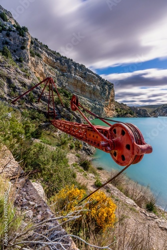 Old Red Industrial Construction Crane near Cueva Foradada Dam in Spain