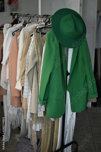 Rack with different stylish women`s clothes 