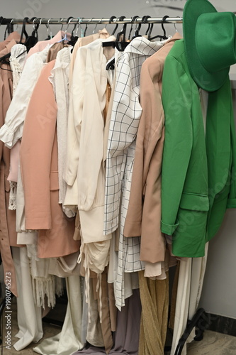 Rack with different stylish women`s clothes 