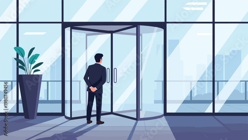 Professional businessman standing in front of a glass revolving door at the entrance of a modern city office building.