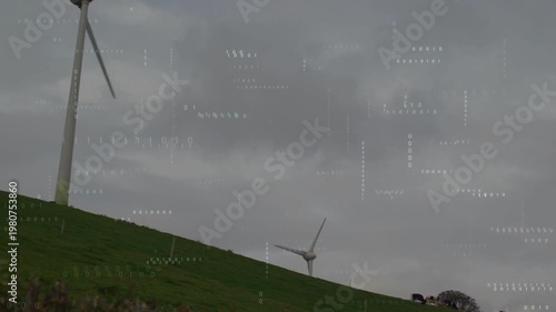 Camera panning and zooming toward turbine, blades rotating, overlay tracking wind farm performance