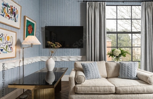 Stylish living space with a modern sofa, artistic decor, and textured accents. Neutral tones emphasize calm and sophistication. High quality photo