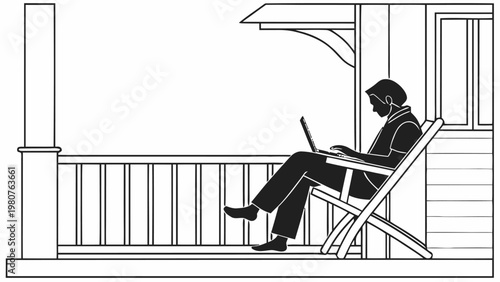 Man working on laptop in outdoor chair on porch at home office in black silhouette
