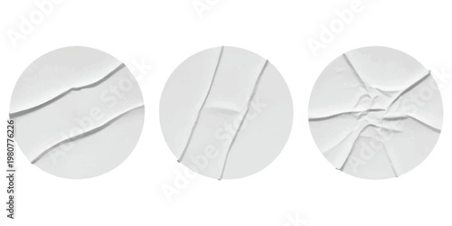 A collection of three round white paper stickers with realistic wrinkles and folded textures set