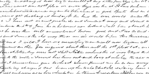 A detailed close up view of an old handwritten letter featuring cursive script on aged paper surface.