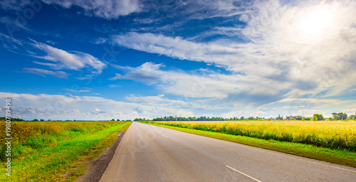 Wallpaper Mural Asphalt road stretches toward distant horizon under bright sky Torontodigital.ca
