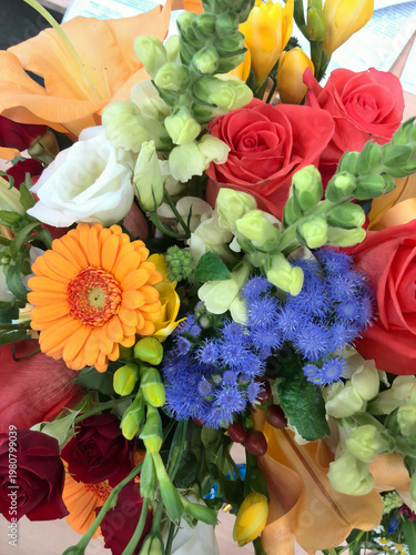 Beautiful mixed flower arrangement featuring gerbera daisies, roses, and statice