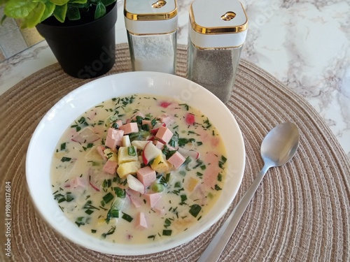 On the table is homemade cold soup with vegetables and meat, it's okroshka