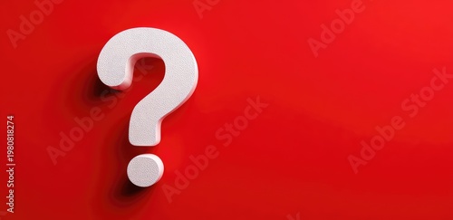 A large, white question mark stands out against a bold red backdrop. The lighting creates subtle shadows. A simple yet striking visual