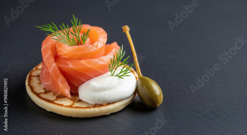 Smoked salmon with cream and capers on a cracker garnish  