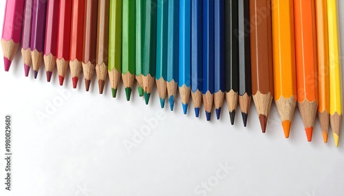 A colorful array of sharpened pencils lined up on a white surface