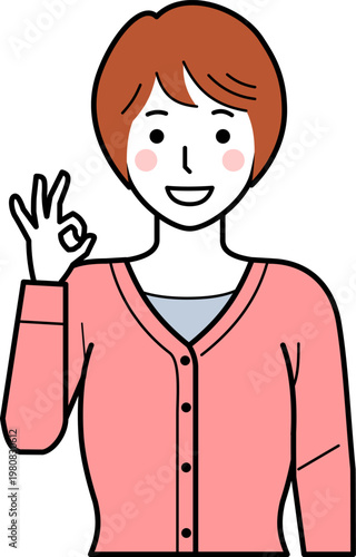 正面向き。OKサインをするカーディガンを着た若い女性。