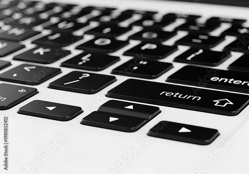 Close up view of a modern computer keyboard with black keys and white text highlighting the return and enter buttons for work