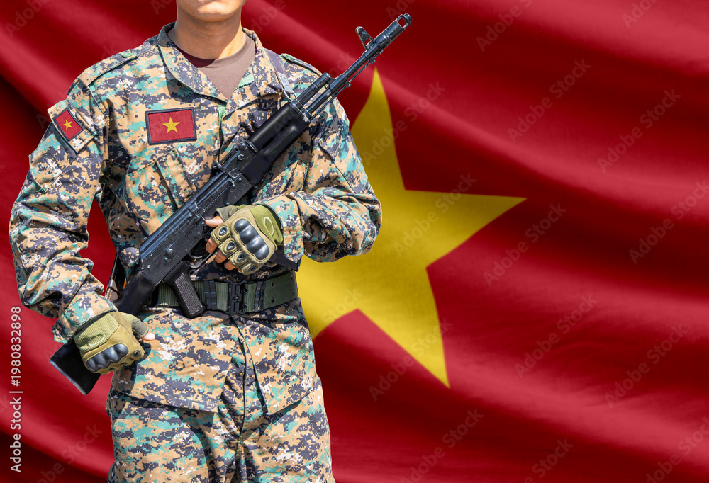 Obraz premium Vietnam flag with soldier holding assault rifle