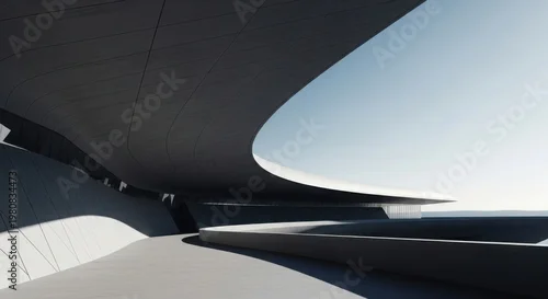 Obraz A sleek, modern architectural structure curves under a clear blue sky with sunlight casting shadows.