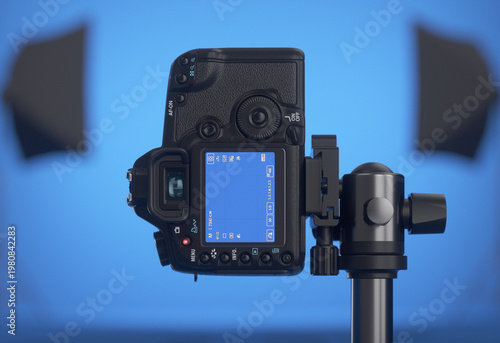 DSLR camera in vertical position on a tripod. Professional studio with a blue background. 3D render.
