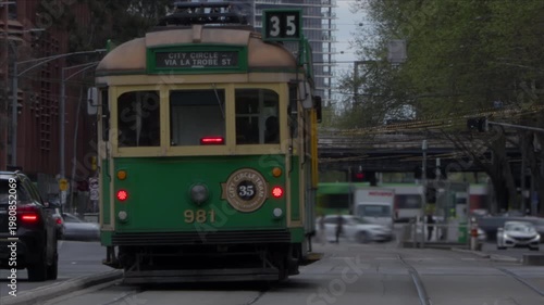 Historic Melbourne Tram at Intersection with Timelapse of Modern City Movement