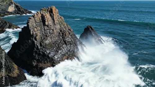 Ocean waves crashing against the rocky cliffs, scenic coastal view.
