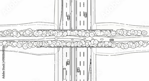 Aerial view of a highway interchange with trees lining the central median