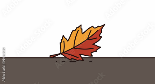 Autumn leaf with red and yellow colors rests on the ground