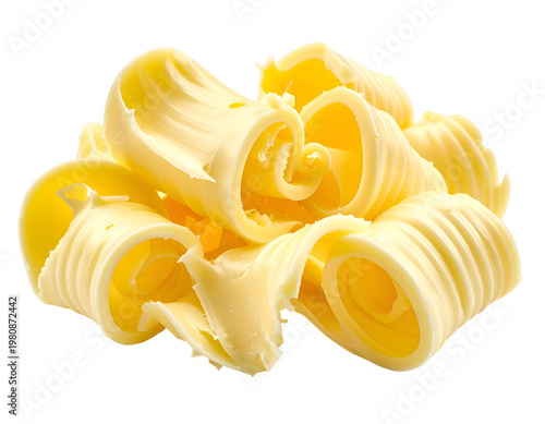 Swirled yellow butter curls piled up against a white background