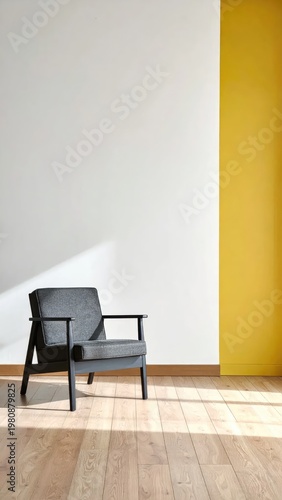 A solitary armchair sits bathed in sunlight against a minimalist wall.