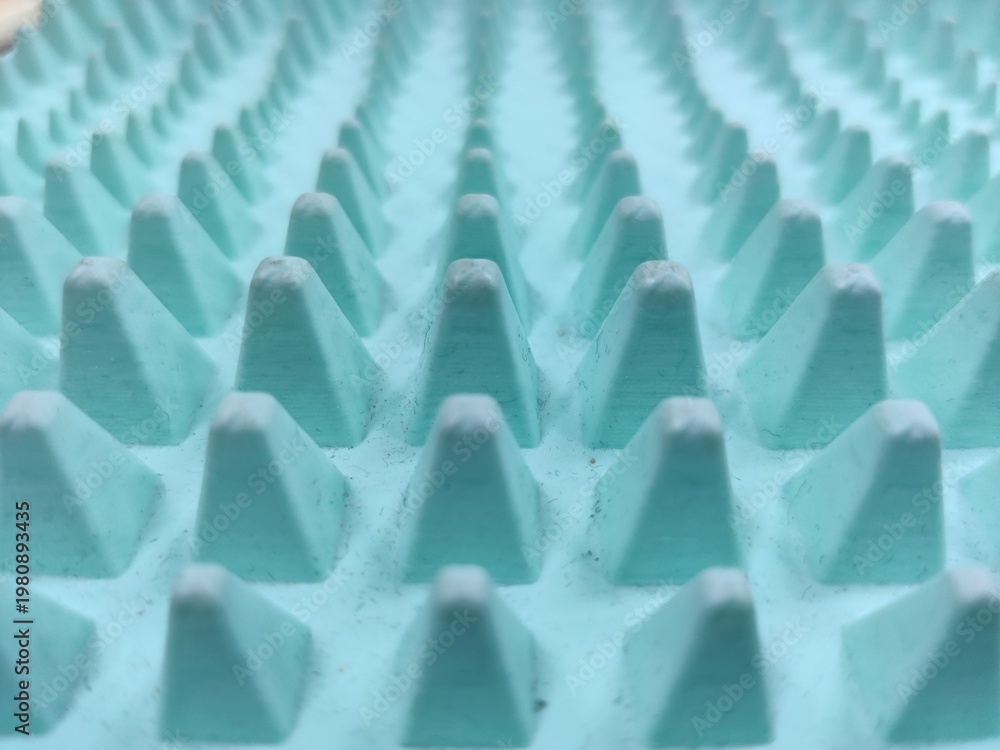 Fototapeta premium macro texture of blue spiked surface in perspective, repeating elements, modern abstract pattern, sharp detail 