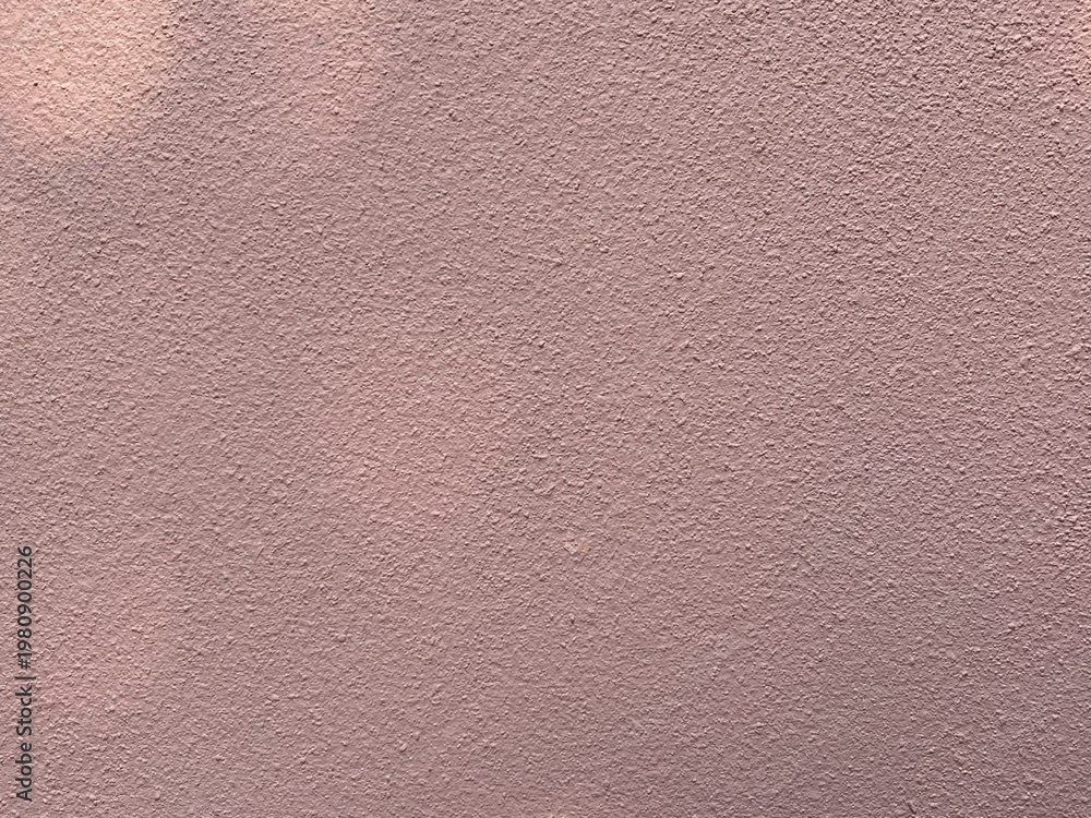 Fototapeta premium Dusty pink plaster wall background with soft matte texture and minimalist aesthetic
