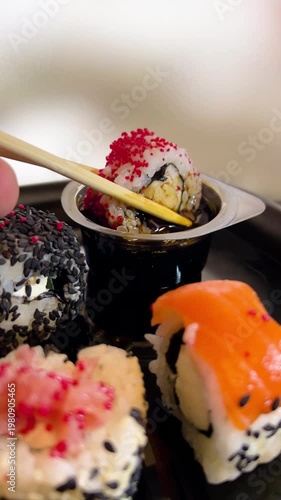 Philadelphia rolls, close-up sushi. Vertical video. Salmon sushi, assorted rice rolls. Ginger and chopsticks.