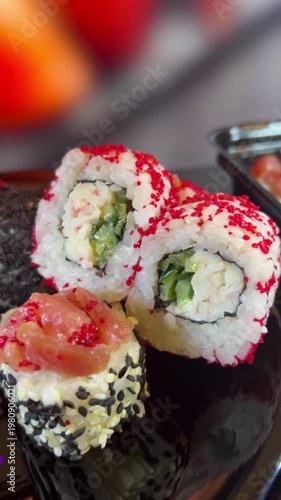 Philadelphia rolls, close-up sushi. Vertical video. Salmon sushi, assorted rice rolls. Ginger and chopsticks.