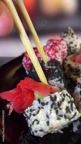 Philadelphia rolls, close-up sushi. Vertical video. Salmon sushi, assorted rice rolls. Ginger and chopsticks.